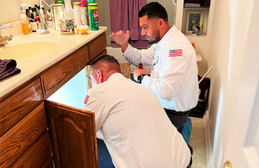 Plumbing Technicians fixing Bathroom Sink Drains